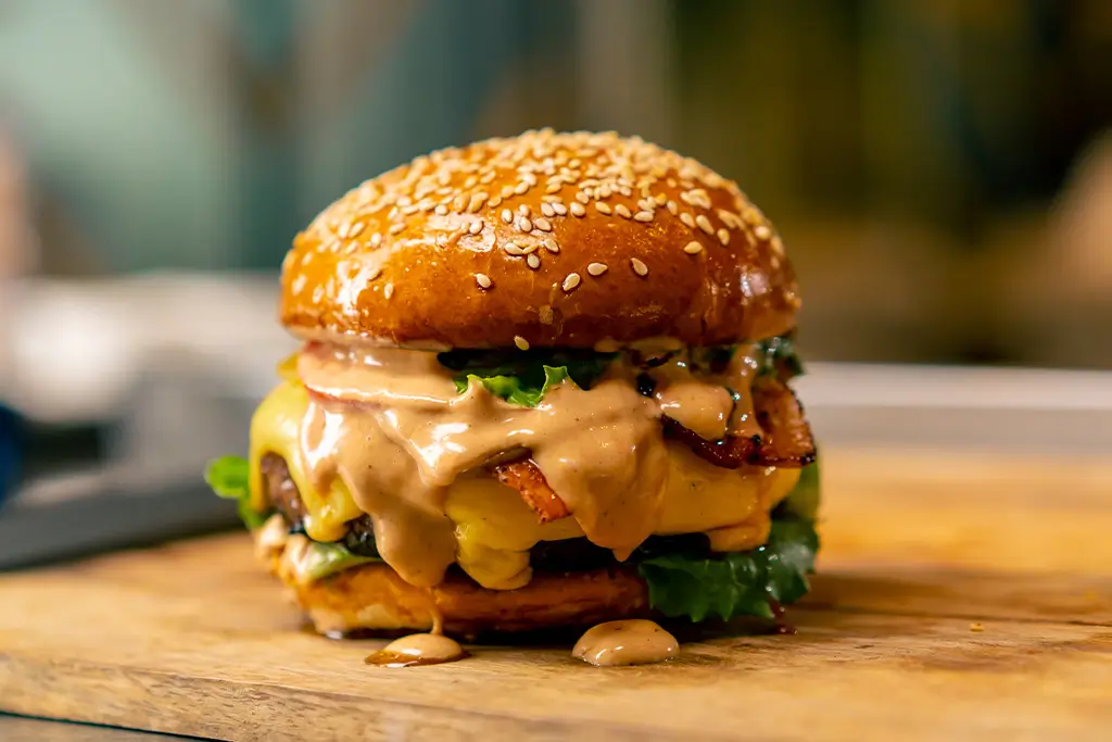 a-close-up-of-a-burger-with-beef-patty-with-vegeta-2024-11-26-10-45-47-utc