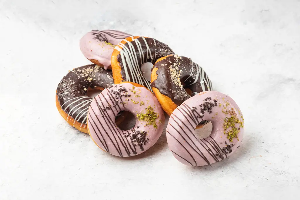 glazed-chocolate-and-pink-donuts-on-marble-backgro-2025-02-10-05-35-43-utc