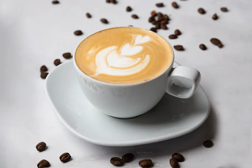 white-coffee-cup-on-a-white-plate-surrounded-by-co-2025-02-11-23-58-35-utc